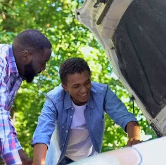 CTE - African American father and son look at car engine