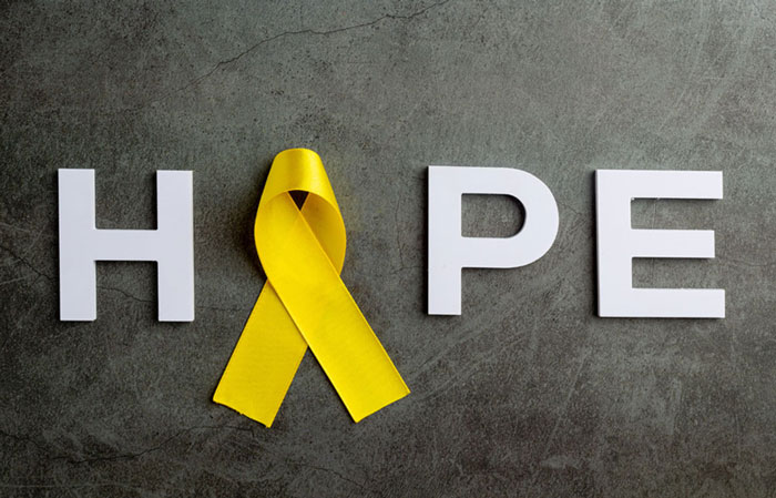 Word hope with yellow ribbon for suicide awareness