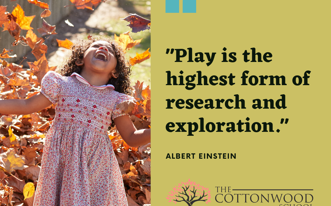 Child playing in fall leaves. Albert Einstein quote reading "Play is the highest form of research and exploration." Cottonwood school logo.