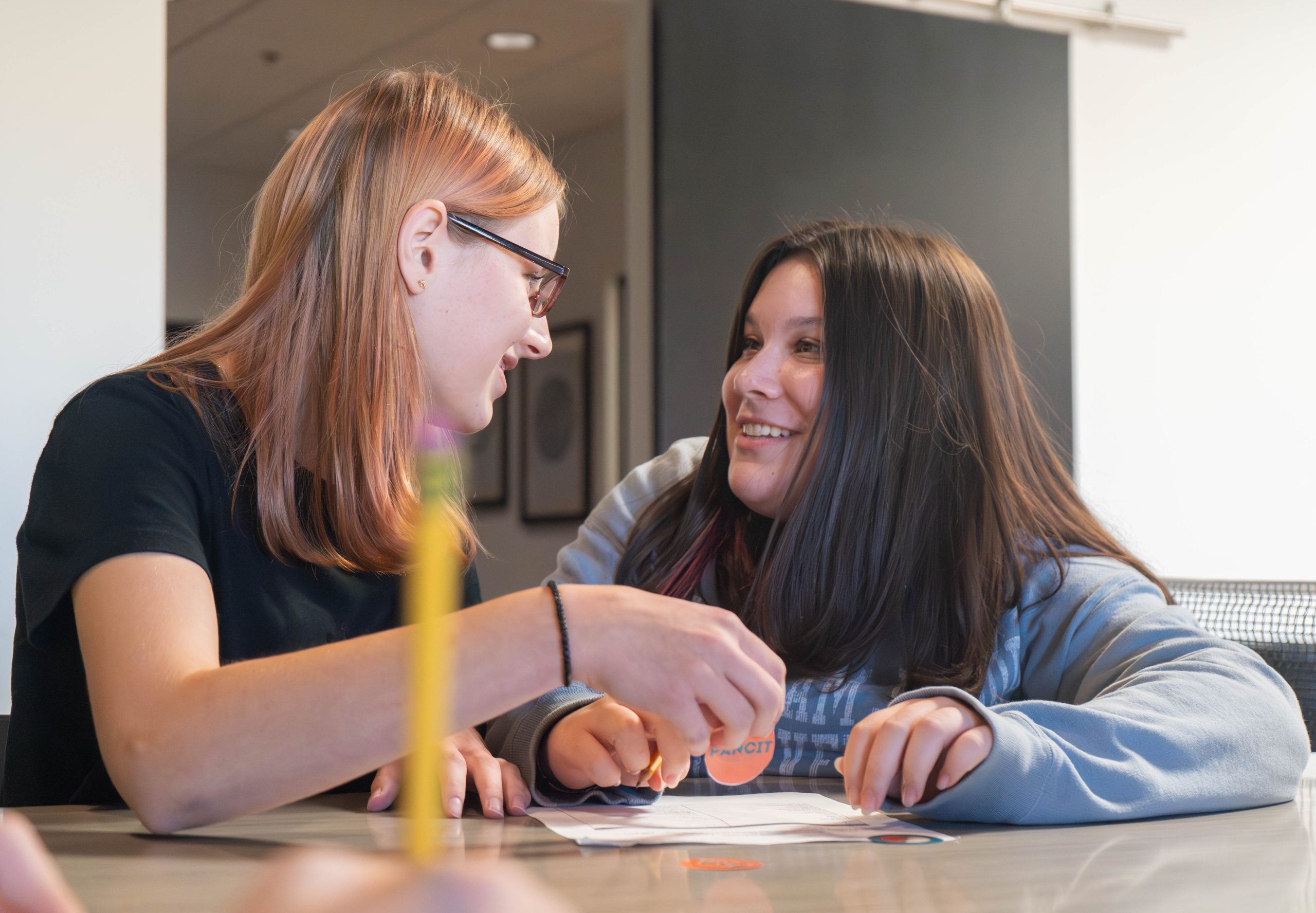 smiling high school students sitting around a table -Cottonwood College Prep Academy